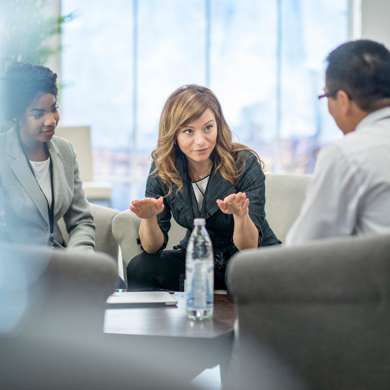 A woman explains a concept to her coworkers